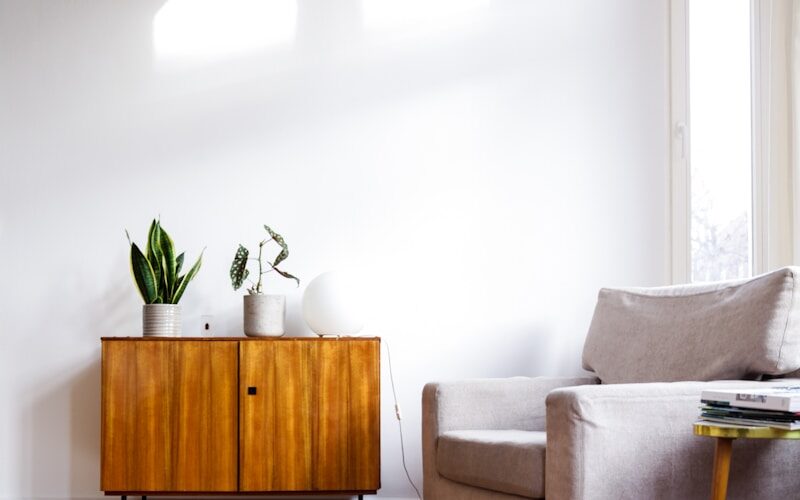 brown wooden table beside gray couch
